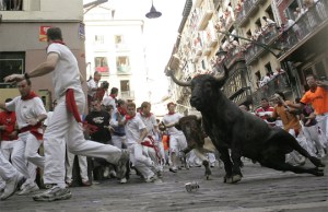 A bull slides upon entering the Estafeta curve during the last running of the bulls in Pamplona